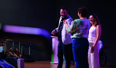 Pessoas no palco durante o evento.